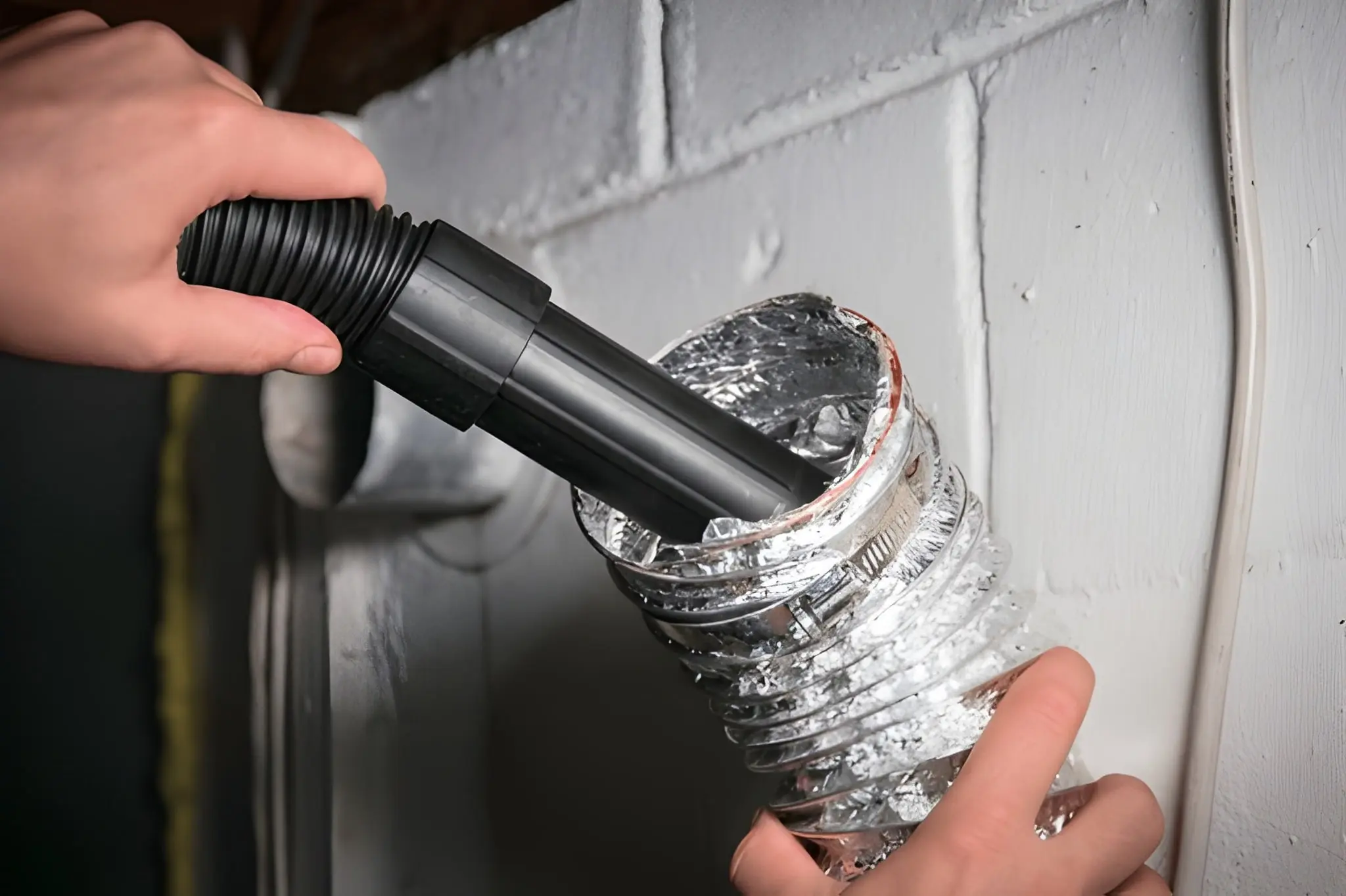Clean Air Pro technician cleaning home air vents in Massachusetts, removing dust and debris for better airflow.